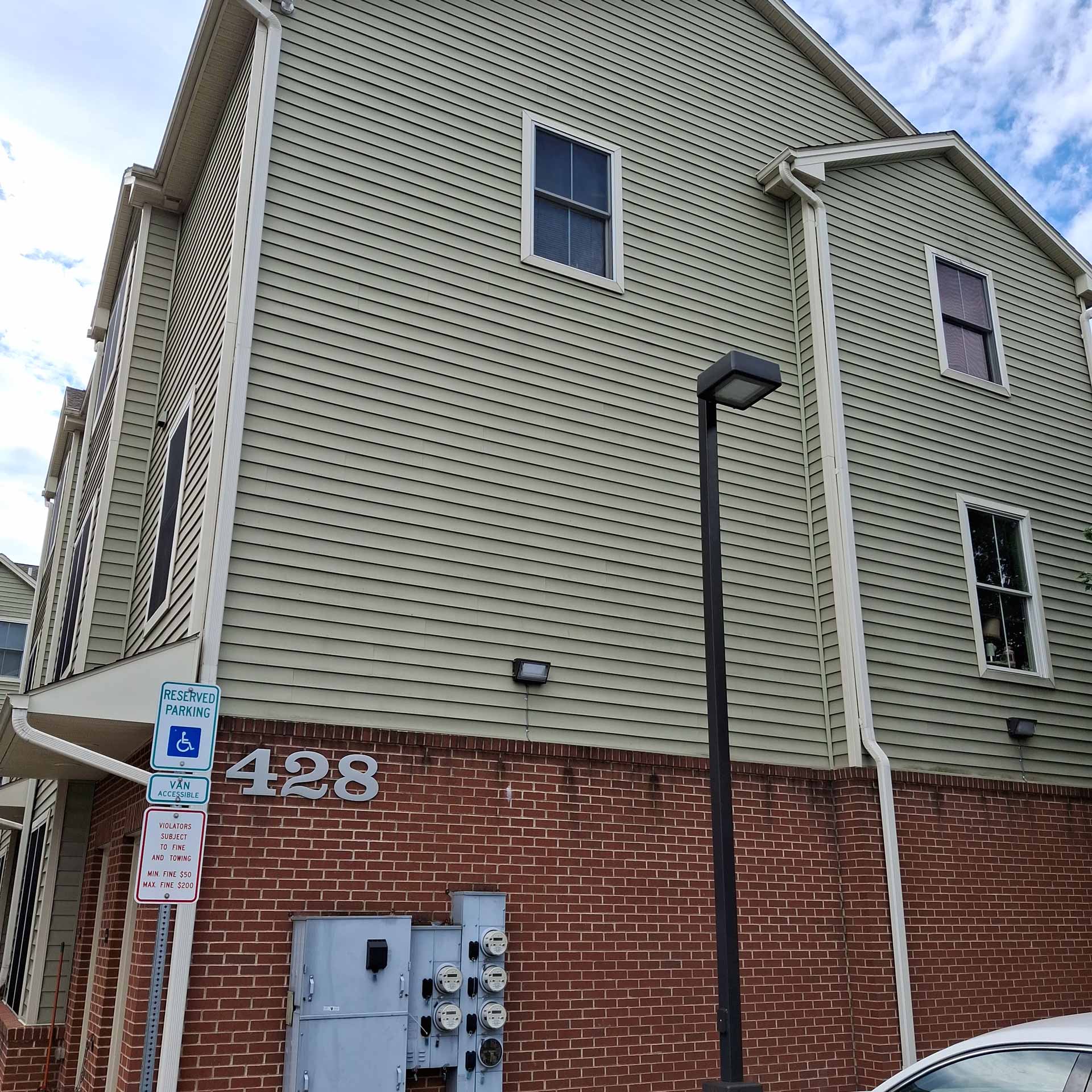 Exterior shot of apartment, showing electric meters