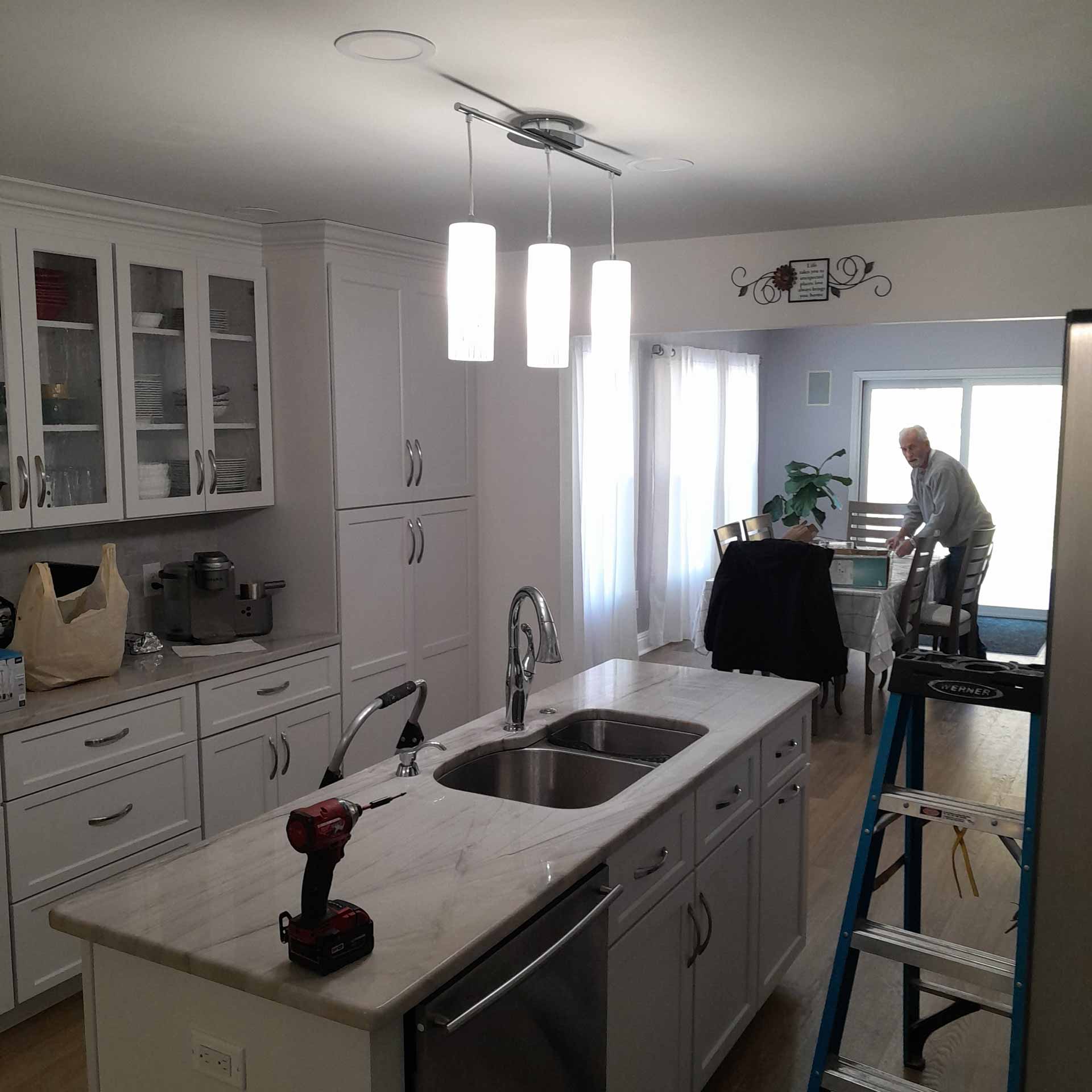 New hanging lights installed over kitchen island