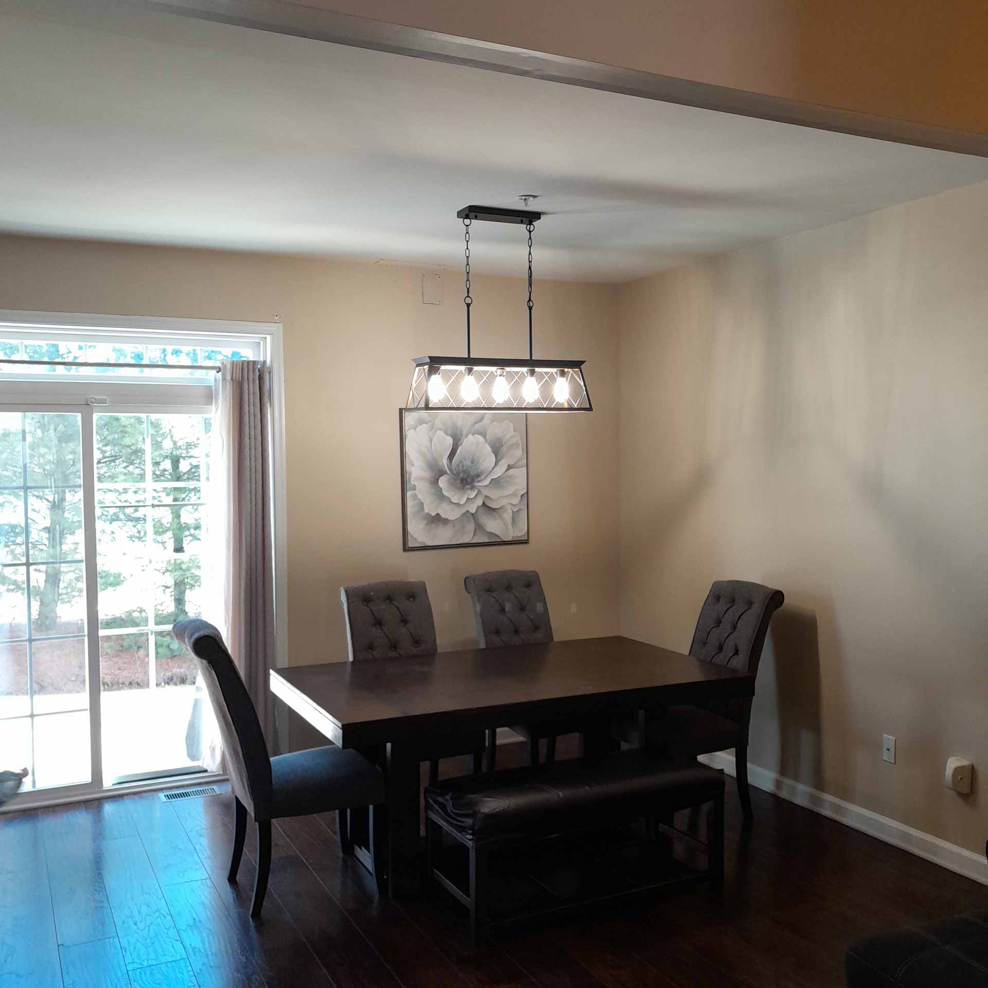 Newly installed hanging lights over dining table