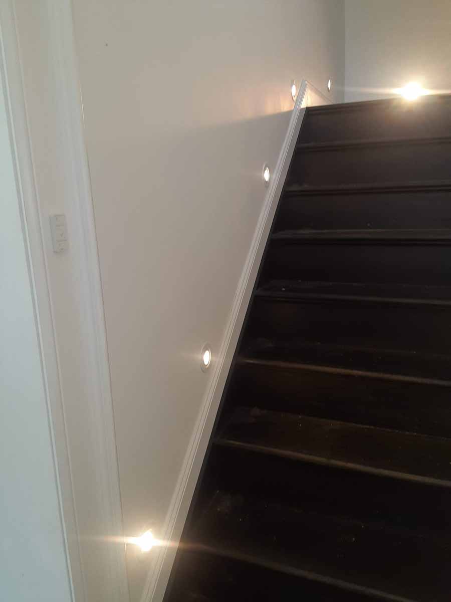 Recessed baseboard lighting on stairs