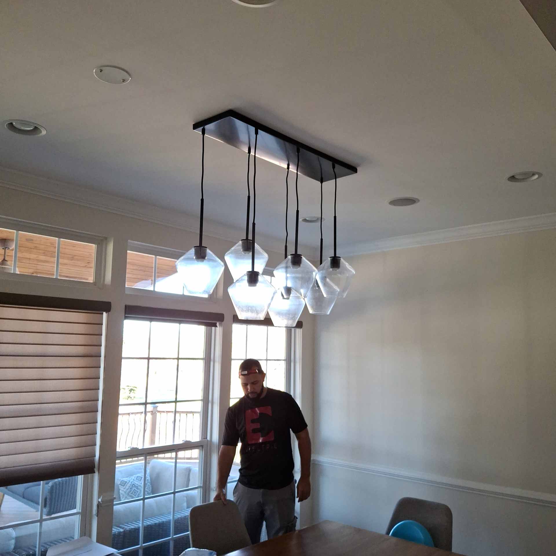 Newly installed hanging lights over dining table